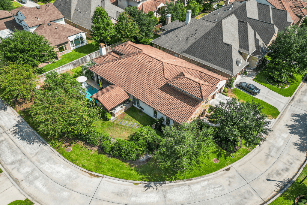 Aerial drone photograph of a Houston-area home and its surrounding neighborhood.