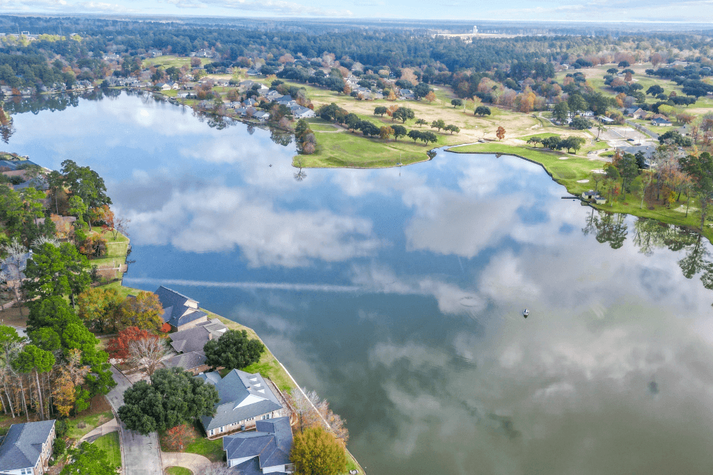 Professional aerial real estate photography of a Huntsville, Texas country property with land
