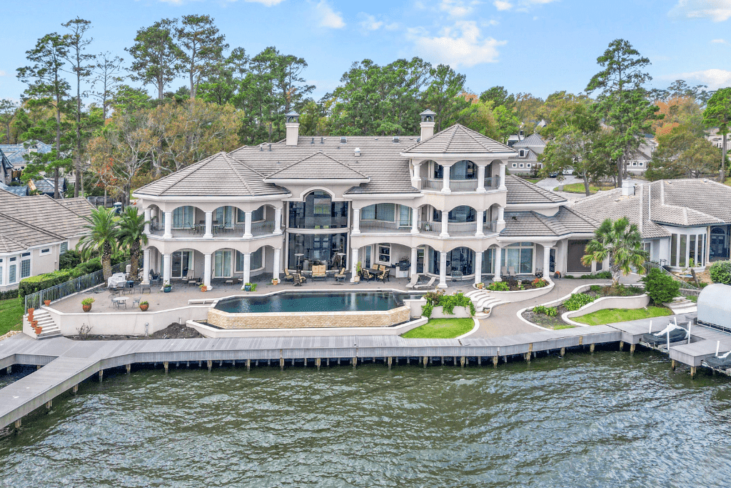 Professional aerial real estate photography showing a Conroe-area home, lot, and surrounding neighborhood